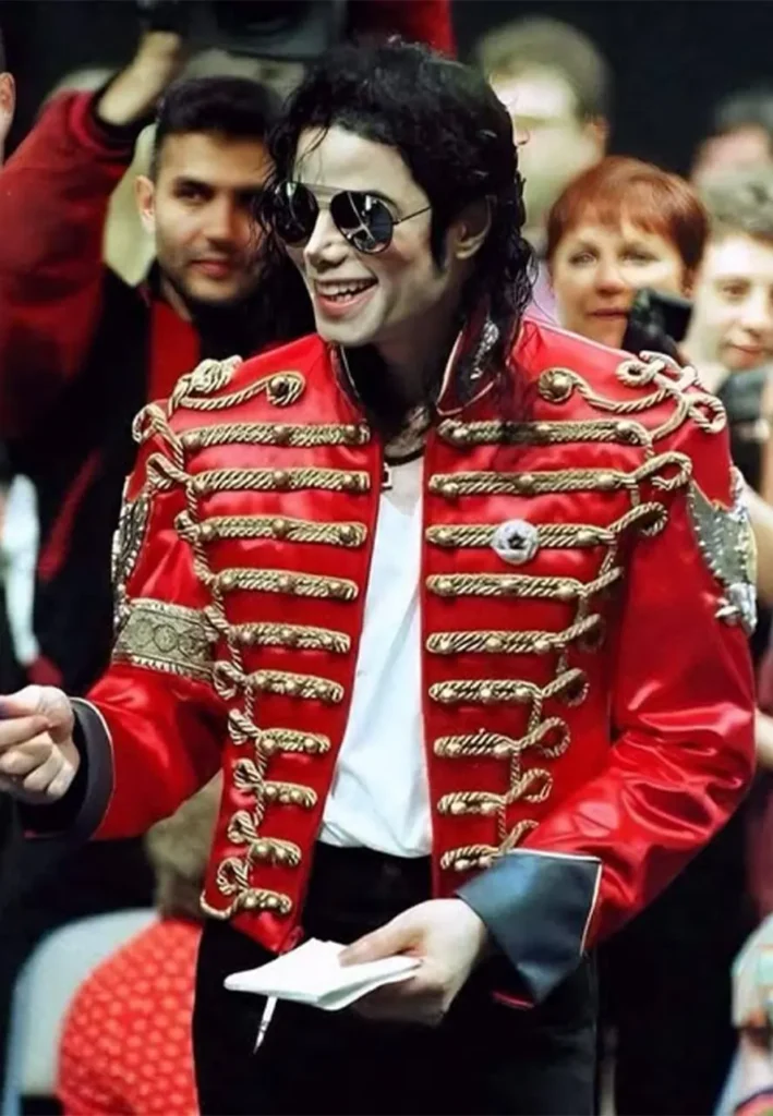 Michael Jackson wearing a red military inspired jacket with gold braiding